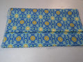 Folded fabric with blue and yellow pattern on a white background