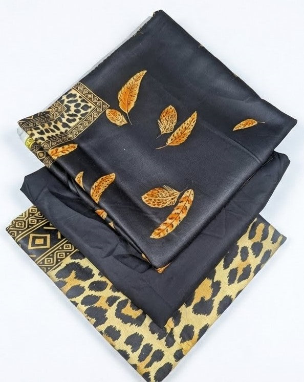 Black fabric with gold leaf patterns and leopard print borders on a white background